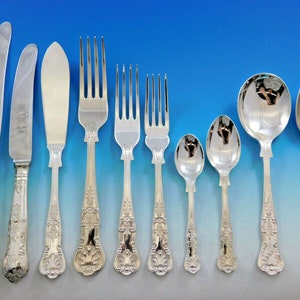 May include: A set of silver flatware with ornate handles. The set includes a dinner knife, a butter knife, a dinner fork, a salad fork, a teaspoon, a soup spoon, and a dessert spoon.