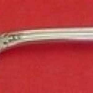 May include: A silver serving fork with a twisted handle and ornate design. The fork has two prongs and a decorative handle.