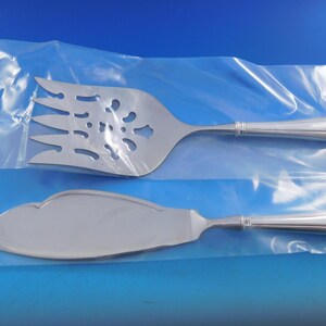 May include: A set of two silver serving pieces, a cake knife and a cake server, in a clear plastic bag.