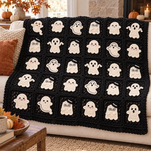 May include: A black crochet blanket featuring a grid of square panels, each decorated with a cream-colored ghost applique. Some ghosts have simple faces, while others wear small black top hats and round glasses, creating a repeating pattern.