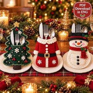 May include: Three crochet cutlery holders shaped like a Christmas tree, a Santa suit, and a snowman. Each holder contains a silver knife, fork, and spoon. The tree is green with white snowflakes, the Santa suit is red with a black belt, and the snowman has a black hat and red scarf. Text reads PDF Download in ENG.
