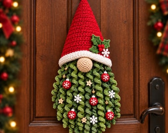 May include: A crocheted Christmas gnome wall hanging featuring a tall red hat with a white brim, a beige nose, and a long curly green beard. The beard is decorated with small red ornaments, white snowflake cutouts, and wooden star accents.