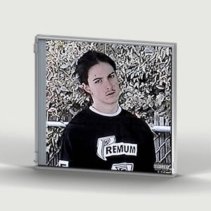 May include: A clear plastic CD jewel case containing an album cover insert. The insert features a person with dark hair wearing a black t-shirt with the white text PREMUM printed on the front. A small Parental Advisory Explicit Content label is visible.