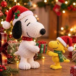 May include: A white crocheted Snoopy figure with black ears wearing a red Santa hat and a red collar, holding a small green gift box, standing next to a yellow crocheted Woodstock figure wearing a red Santa hat and a green scarf.