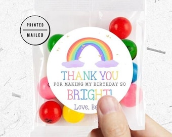 May include: Rainbow-themed thank you favor bags with a rainbow, clouds, and the text "Thank you for making my birthday so bright! Love, [Name]" printed on the front.
