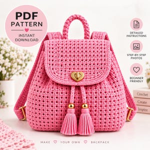 May include: A bright pink crocheted backpack featuring a heart-shaped gold-tone metal turn-lock closure on the front flap, two matching pink tassels with gold-tone caps, a top handle, and adjustable shoulder straps with gold-tone metal hardware.