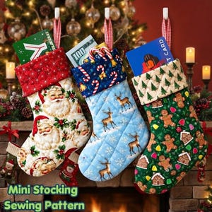 May include: Three quilted Christmas stockings hanging in a row. The left stocking features Santa Claus faces, the middle one shows reindeer and candy canes on a light blue background, and the right one displays gingerbread men and houses.