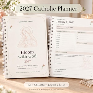 May include: A 2027 Catholic planner with a white spiral binding. The cover features a line drawing of the Virgin Mary, the text 'Bloom with God', and small floral accents. The open page displays a daily schedule, priority list, and prayer prompts.