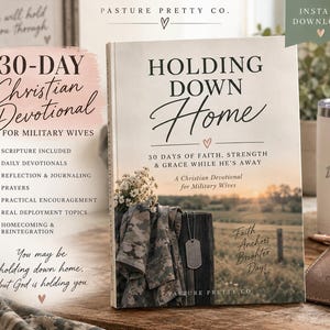 May include: A hardback book titled Holding Down Home, a 30-day Christian devotional for military wives. The cover displays a camouflage jacket, a silver dog tag, and a rural landscape. Text includes 30 Days of Faith, Strength & Grace While He's Away and Faith Anchors Brighter Days, alongside a list of devotional features.