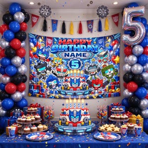 May include: A birthday party display featuring a large backdrop with Transformers characters, the text HAPPY BIRTHDAY NAME, and a number 5. A tiered cake with a robot face design sits on a table with cupcakes, candy jars, and a silver number 5 balloon.