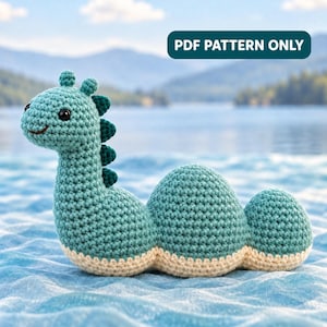 May include: A teal crochet dinosaur toy with a long neck, a rounded body, and a tail. The creature features dark teal spikes along its back, black bead eyes, and a cream-colored underside. The text PDF PATTERN ONLY is visible above.