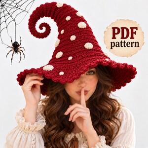 May include: A deep red crocheted hat with a tall, curled point and a wide, wavy brim. The hat is decorated with small, round, cream-colored spots scattered across the surface. A circular badge in the upper right corner displays the text PDF pattern.