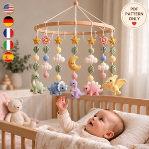 May include: A crochet mobile featuring a circular wooden frame with hanging strings of yarn dinosaurs, stars, flowers, clouds, and leaves in pastel colours. The text PDF PATTERN ONLY is visible in the upper right corner of the image.