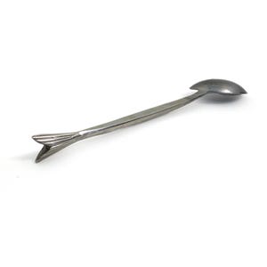 May include: A silver-colored bar spoon with a spoon-shaped bowl at one end and a forked tail design at the other. The spoon is designed for mixing drinks and has a long, slender handle.