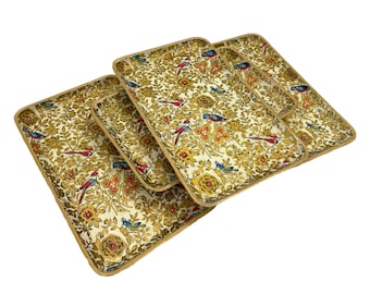 May include: Set of four rectangular serving trays. Each tray features a gold floral and bird pattern with red, blue, and yellow accents. The trays have a gold trim and are arranged in a layered display.