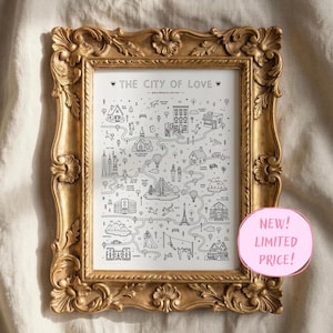 May include: A framed print titled THE CITY OF LOVE featuring a black and white illustrated map with various landmarks, buildings, and figures connected by winding paths, encased in an ornate, textured gold-colored decorative frame.