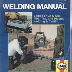 May include: A blue Haynes Techbook Welding Manual with white text. The cover features images of welding processes, including gas, arc, MIG, TIG, and plasma cutting. It displays a person wearing a welding helmet and gloves working on a metal project.