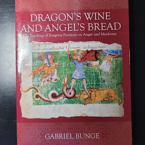 May include: A book titled Dragon's Wine and Angel's Bread: The Teaching of Evagrius Ponticus on Anger and Meekness by Gabriel Bunge. The red cover features a medieval-style illustration of a figure standing over a lion and a serpent.
