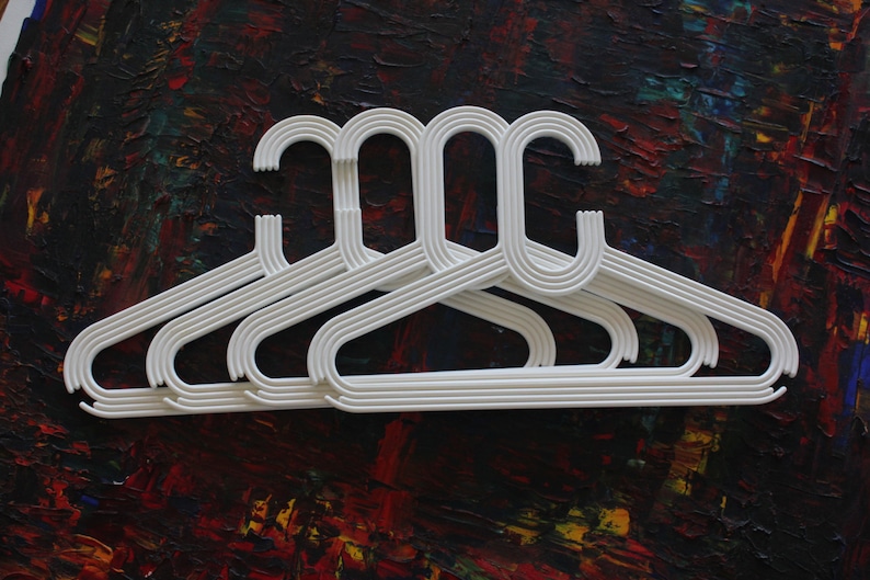 made by Karhumuovi Finland Truly and sincerely retro and cool designer white plastic hanger set of 4