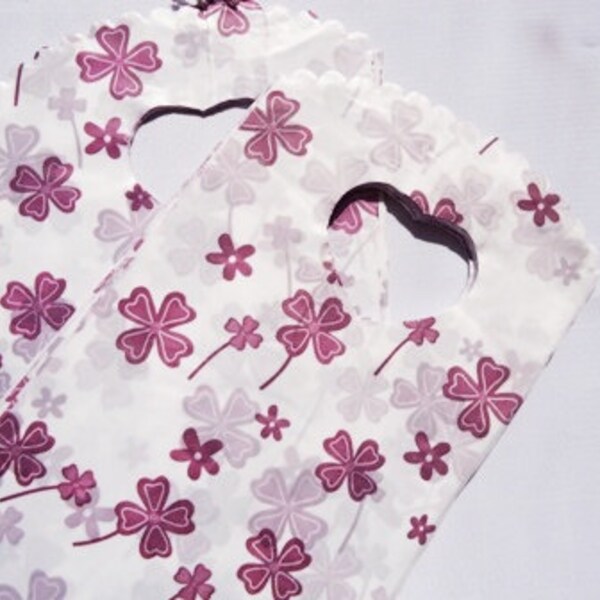 50pc small white plastic gifting bags with burgundy 4 leaf clover print, 8.5x15cm