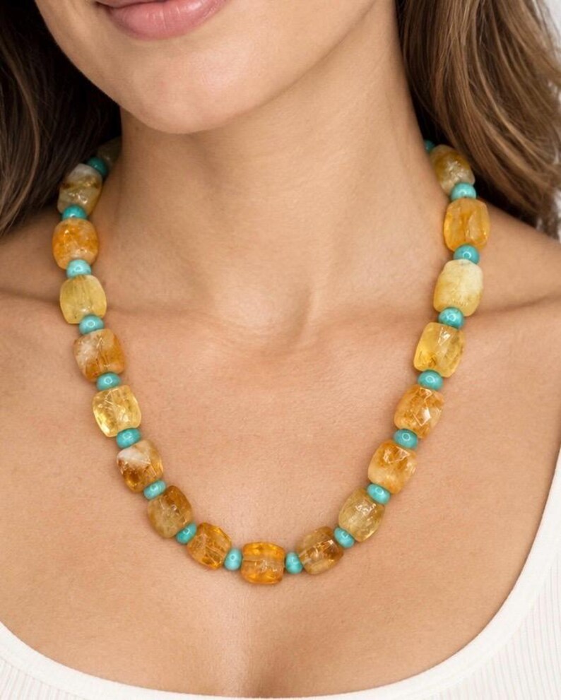 The Portofino necklace worn with a white top: golden-yellow citrine nuggets alternating with small round turquoise-colored beads.