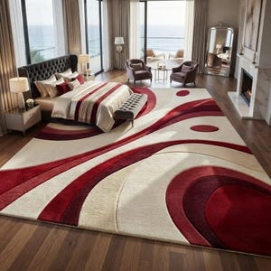May include: A large rectangular area rug featuring a high-low pile texture with abstract, sweeping curves and circular shapes in shades of deep red, burgundy, and cream. The rug covers a significant portion of the wooden floor in a bedroom.