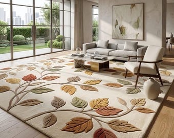 May include: A large area rug featuring a cream-colored background with a raised, three-dimensional pattern of autumn-toned leaves in shades of orange, brown, and sage green. The leaves are connected by flowing, vine-like stems across the surface.