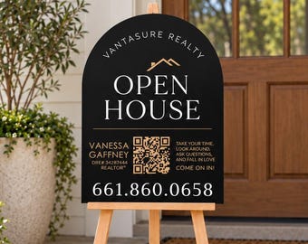 May include: A black arched sign on a wooden tripod stand featuring the text VANTASURE REALTY, OPEN HOUSE, VANESSA GAFFNEY, a QR code, and the phone number 661-860-0658. The sign includes the text TAKE YOUR TIME, LOOK AROUND, ASK QUESTIONS, AND FALL IN LOVE COME ON IN!