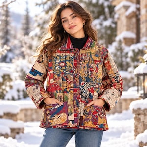 May include: A quilted jacket featuring a vibrant patchwork pattern with red, blue, and gold tones. The garment has a collared neckline, long sleeves, and two large front pockets. The fabric displays intricate illustrations of figures and musical instruments.