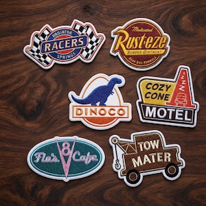 May include: Six embroidered fabric patches featuring designs from the Cars movie franchise: Radiator Springs Racers, Rust-eze, Dinoco with a blue dinosaur, Cozy Cone Motel, Flo's V8 Cafe, and a brown Tow Mater tow truck graphic.