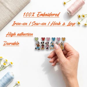 May include: An embroidered patch featuring a line of six cartoon characters holding colorful balloons. The text on the image reads 100% Embroidered, Iron-on / Sew-on / Hook & Loop, High adhesion, and Durable. The patch is held against a white background.