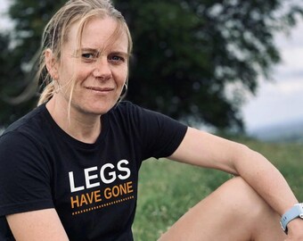 May include: A black short-sleeved t-shirt featuring the white text LEGS and the orange text HAVE GONE printed on the front. The shirt has a crew neckline and a standard fit, with the text positioned clearly across the chest area of the garment.