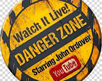 May include: A circular pinback button featuring a yellow and black hazard-style background. The text reads Watch It Live! DANGER ZONE Starring John Ordover, accompanied by a red YouTube logo. The design has a distressed, weathered texture.