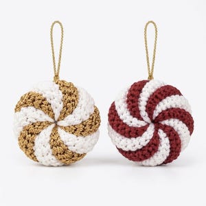 May include: Two round crochet ornaments with a spiral pattern. One ornament features alternating white and metallic gold yarn, while the other features alternating white and deep red yarn. Each piece includes a gold cord loop for hanging.