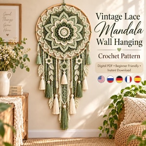 Op de afbeelding: Een ronde wandhanger met een gehaakte mandala in saliegroen, crème en wit. Het ontwerp bevat hangende kantelementen, bladvormige haakmotieven en kwastjes. Tekst: Vintage Lace Mandala Wall Hanging.