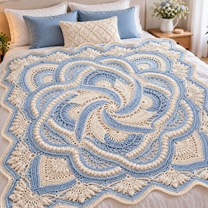 May include: A large, rectangular crochet blanket featuring a complex, swirling mandala-inspired pattern in alternating shades of cream and light blue. The design includes intricate fan-shaped motifs, raised bobble stitches, and a scalloped edge.