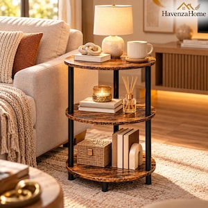 May include: A three-tier round side table with a dark brown faux wood grain finish and black metal support poles. The table features three circular shelves, providing storage space for books, a small woven box, a candle, and a reed diffuser.