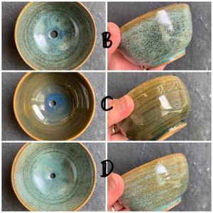 May include: Four ceramic bowls with a green and brown glaze. The bowls have a round shape and a small hole in the center of the bottom.