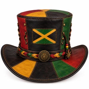 May include: A top hat featuring a patchwork design in red, yellow, green, and black. The hat includes a rectangular patch with a yellow cross on a green background, a braided band with a lion emblem, and a small metal leaf charm with beads.