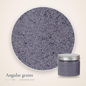 Close-up of Lavender Mist craft sand showing angular grains 0 to 1 mm, with a small closed jar in the corner