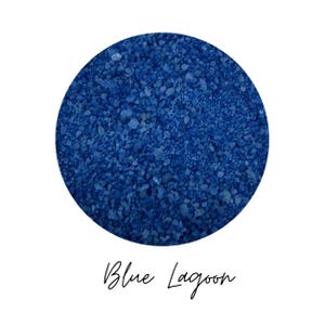 Close-up swatch of Blue Lagoon blue colored quartz sand showing the fine mineral grain texture