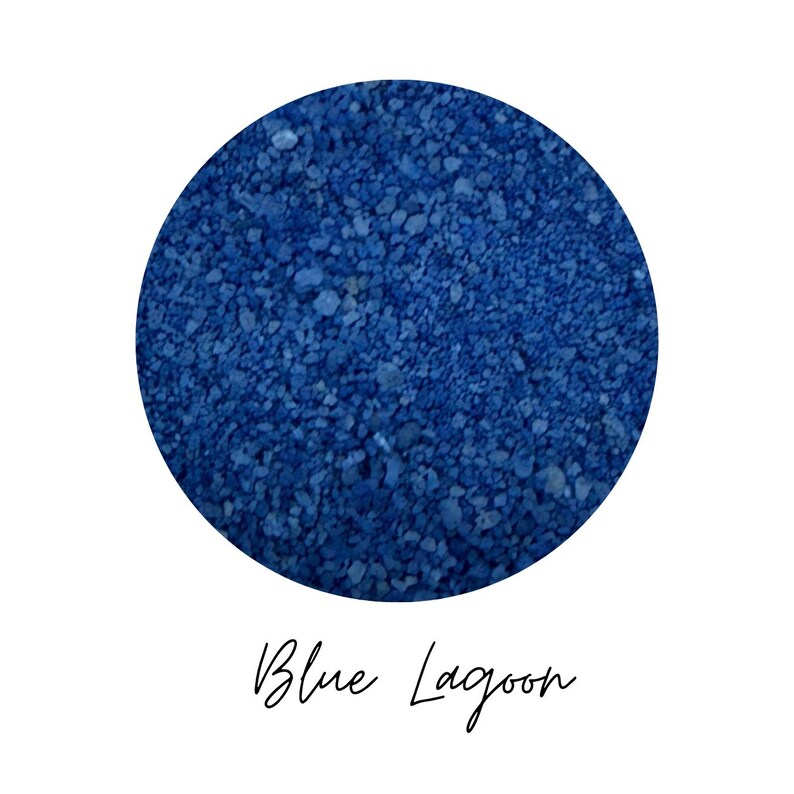 Close-up swatch of Blue Lagoon blue colored quartz sand showing the fine mineral grain texture