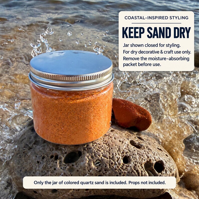Closed clear jar of bright orange colored quartz sand with a silver metal screw lid on a porous rock at the shoreline, with sea water splashing around it. Text: Coastal-inspired styling, Keep Sand Dry. Jar shown closed for styling, for dry decorative and craft use only, remove the moisture-absorbing packet before use. Only the jar of colored quartz sand is included, props not included.