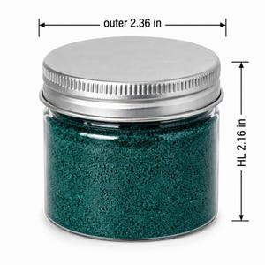 Closed clear jar of deep teal green colored quartz sand with a silver metal screw lid, with measurement lines showing an outer diameter of 2.36 in (6 cm) and a height of 2.16 in (5.5 cm), on a white background.