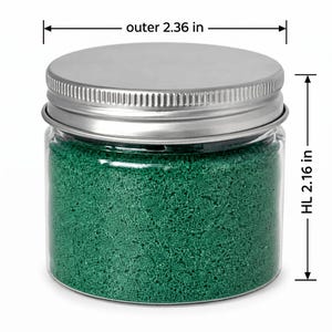 Closed clear jar of Lagoon Green colored quartz sand in an emerald green, with a silver metal screw lid, with measurement lines showing an outer diameter of 2.36 in (6 cm) and a height of 2.16 in (5.5 cm), on a white background.