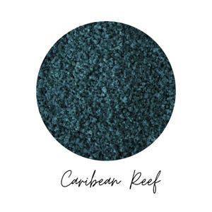 Close-up swatch of Caribbean Reef teal colored quartz sand showing fine granular quartz texture