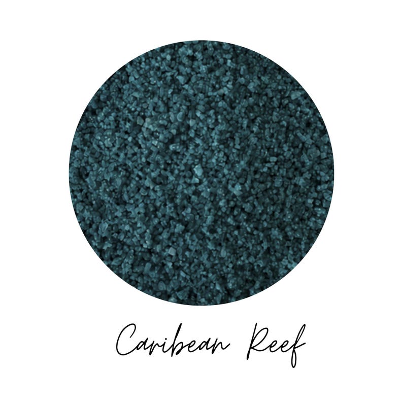 Close-up swatch of Caribbean Reef teal colored quartz sand showing fine granular quartz texture