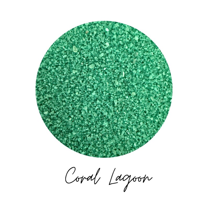 Close-up circle swatch of Coral Lagoon jade green craft sand with the color name written below