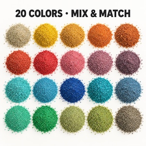 Color chart of 20 piles of loose colored quartz sand on a white background in four rows, from beige, yellow, gold and orange to red, pink, mauve, plum, turquoise, blues, teal, greens, olive and charcoal grey, showing the fine grain texture. Text: 20 Colors, Mix and Match.