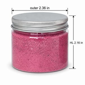 Closed clear jar of rose pink colored quartz sand with a silver metal screw lid, with measurement lines showing an outer diameter of 2.36 in (6 cm) and a height of 2.16 in (5.5 cm), on a white background.